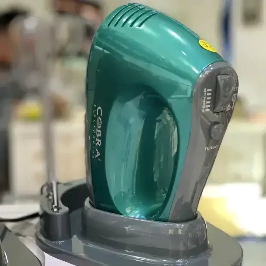 Batteur cobra électrique teal et gris avec design ergonomique et table de pose intégrée
