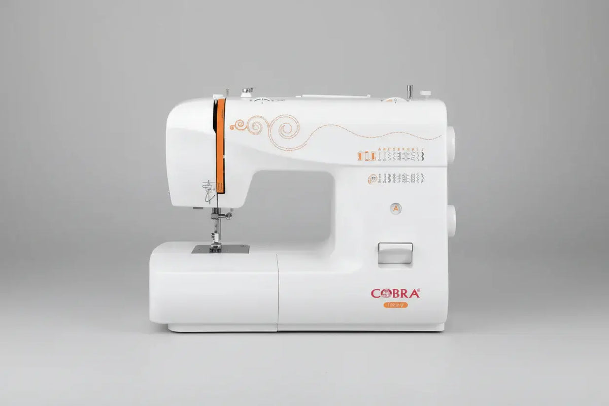 Machine à coudre 1930-v blanc avec cobra, accents orange et arabesques décoratives sur le côté