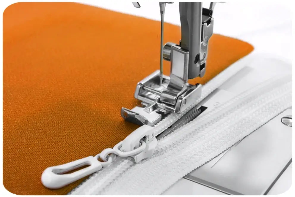 Machine à coudre 2120-v avec fermeture éclair blanche cousue dans tissu orange sous le pied de la machine