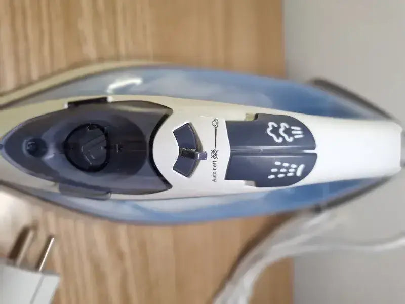 White and blue 2200 watt steam iron with black control dials and auto reset label for effective ironing